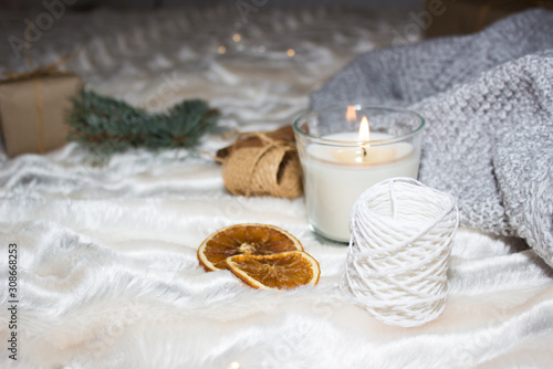 Cozy winter composition. Candle, cinnamon, oranges and other cute elements