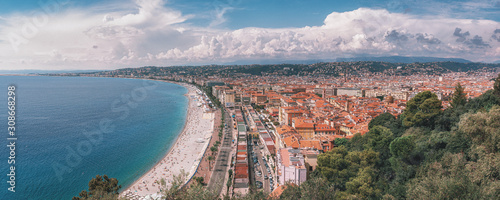 Panorama photo of the public baths Plage de Castel and Plage des Ponchettes in the French city of Nice with the well known promenade quai des etats Unis along photo