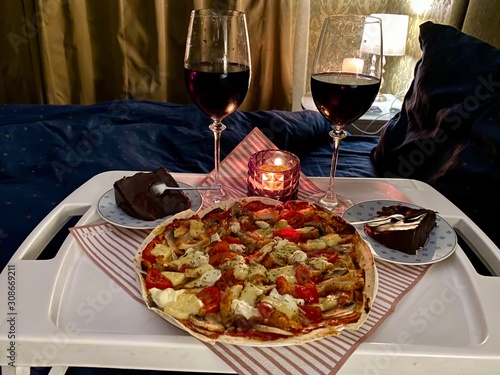 dinner with red wine and pizza in bed