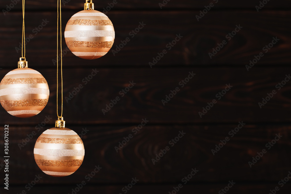Christmas balls hanging  on  dark  wooden background