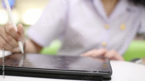 woman using tablet computer in Library.do homework.New style of education