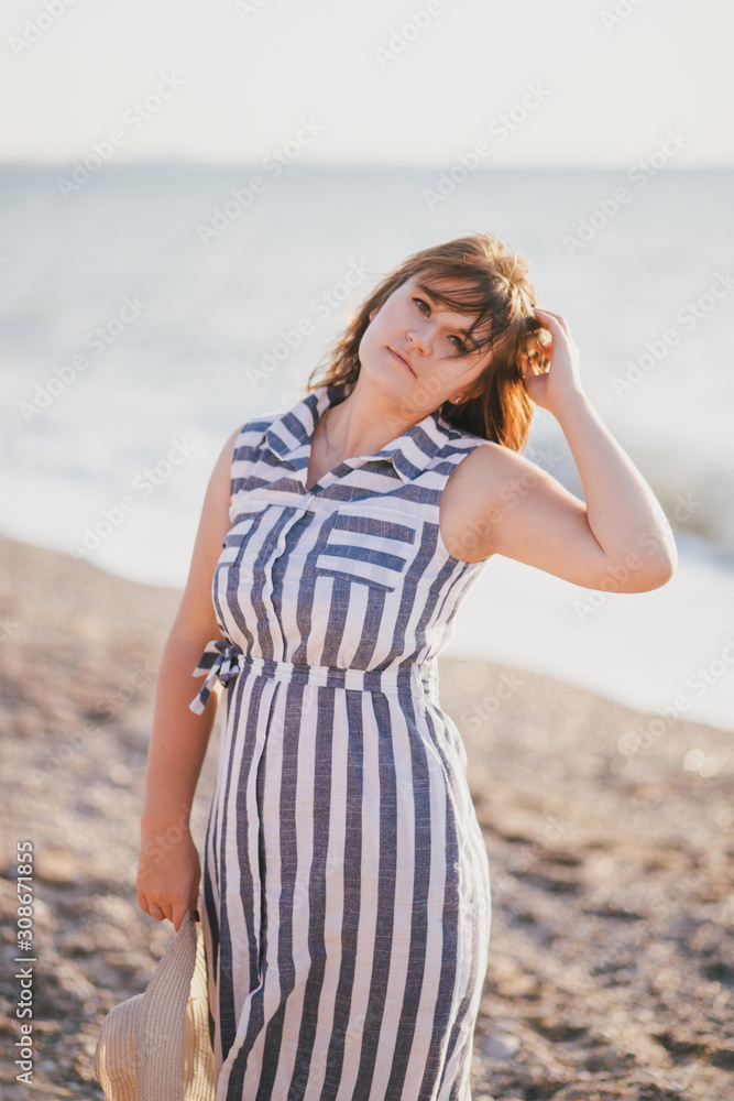 Happy plus size woman relaxing at the beach. Happy plus size woman relaxing at the beach.