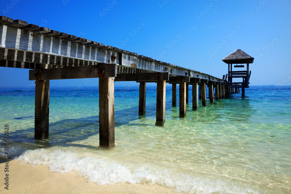 Wooden bridge extended into the sea.