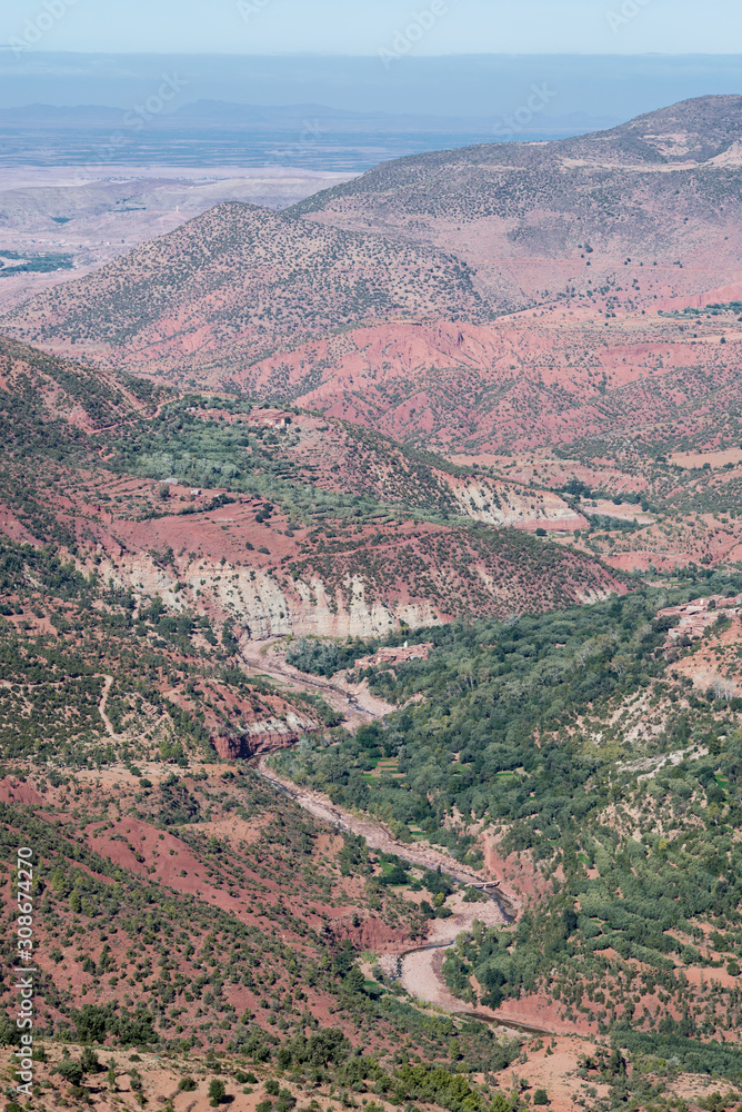 Landscape of the Atlas Mountains and the riverbed with colored land in Morocco.