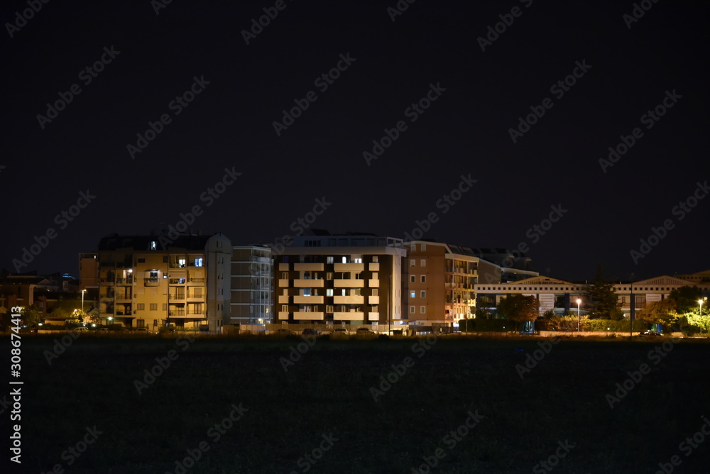 Night Illuminated City Houses Over the Garden