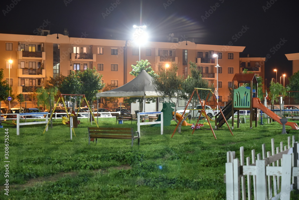 Fototapeta premium Night Child Playground in the City Illuminated by Lamps