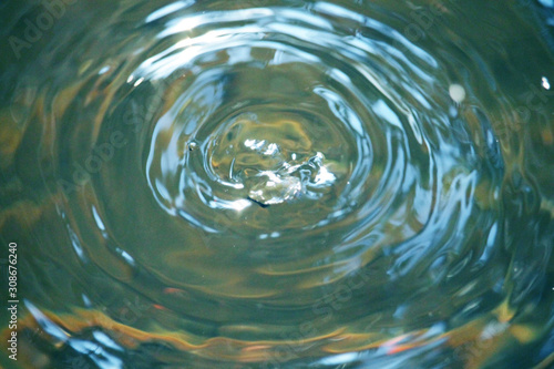 Blurred water drop bounces up in a splash.