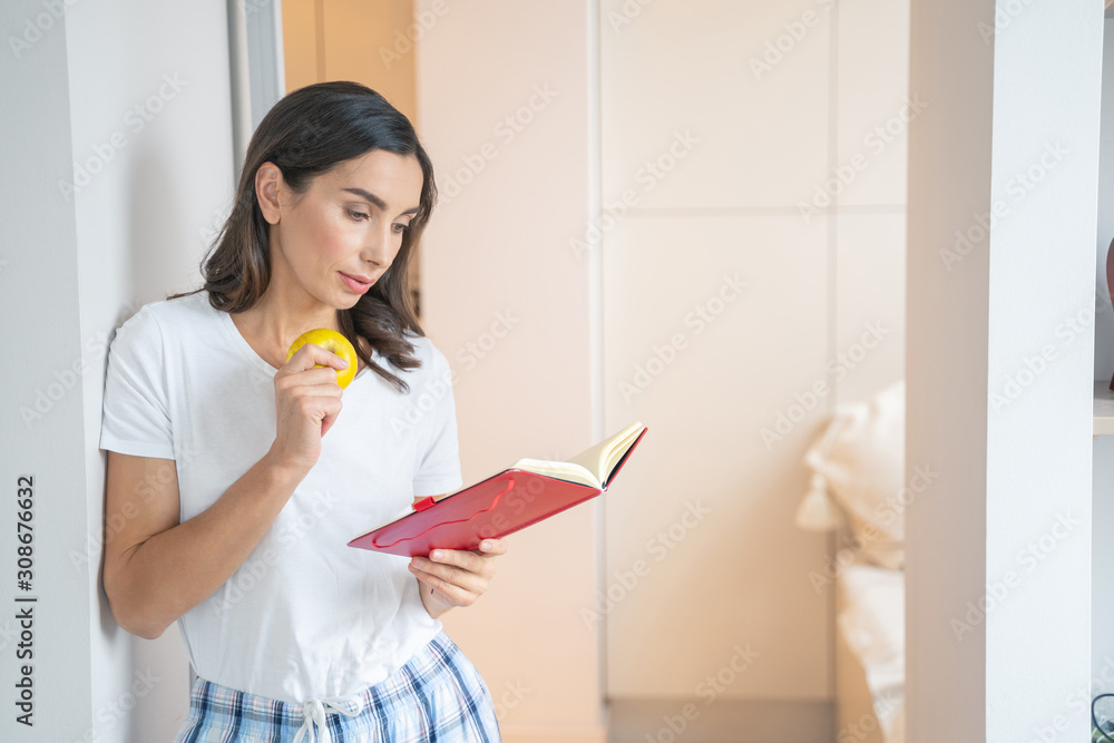 Calm woman reading and looking interested stock photo Calm woman reading and looking interested stock photo