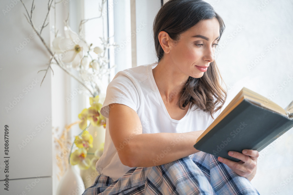 Calm woman with interesting book stock photo Calm woman with interesting book stock photo