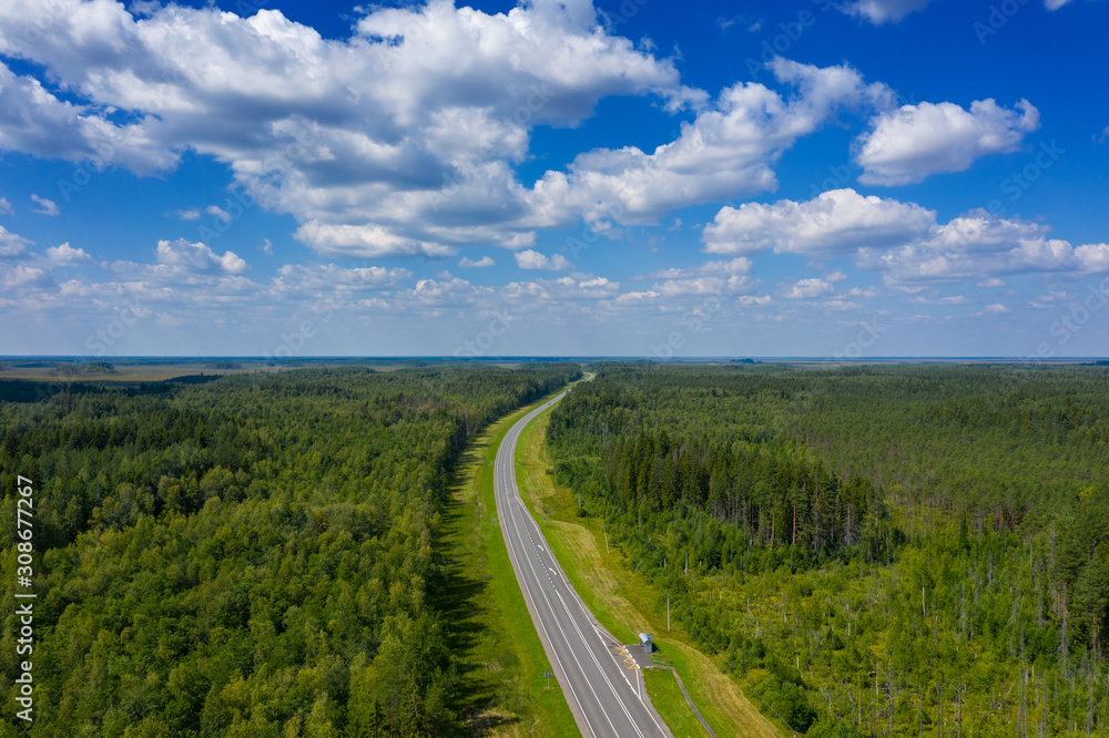 Aerial top view landscape with a country road in the forest at summer