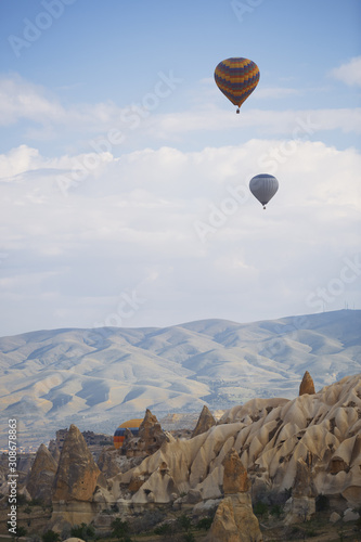 Hot air balloons flying over the rocky land