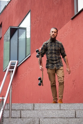 Wallpaper Mural young man with beard and gauged pierced ears and skateboard Torontodigital.ca