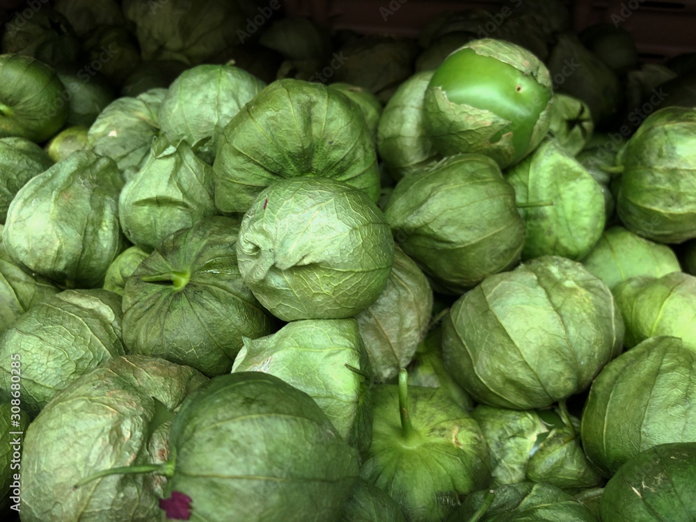 Close up of piles of tomatillos at a fresh produce section Close up of piles of tomatillos at a fresh produce section