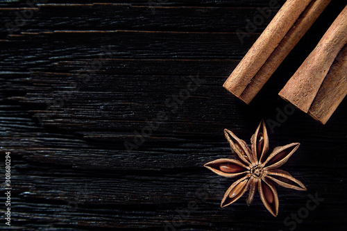 Christmas time spices - star anise with cinnamon on dark wooden background