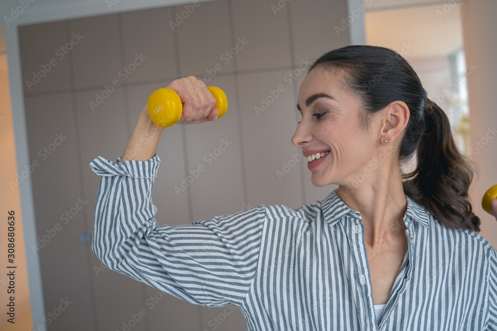Training muscles with hand weights stock photo Training muscles with hand weights stock photo