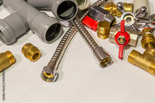Spare parts and accessories for plumbing repair on a gray background