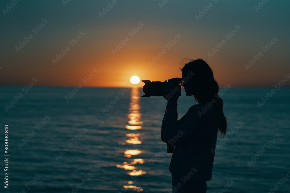 silhouette of woman on the beach at sunset