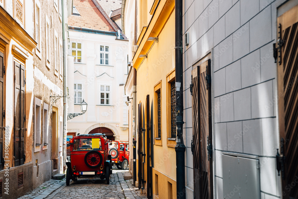 Fototapeta premium Old town street and city tour car in Bratislava, Slovakia