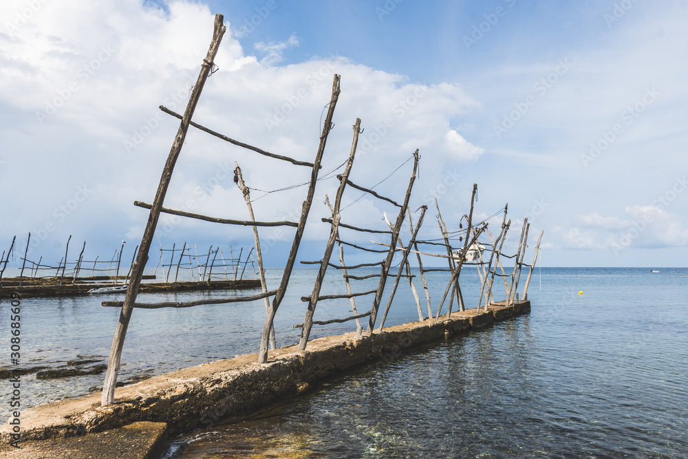 The old docks with the typical wooden cranes of Savudrija, a small fishing village in Croatia