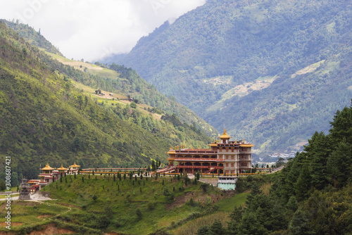 Tibetan-style monastery stands on a hill surrounded by forest, photo taken in the Indian state of Arunachal, Dirang village photo