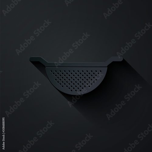 Paper cut Kitchen colander icon isolated on black background. Cooking utensil. Cutlery sign. Paper art style. Vector Illustration