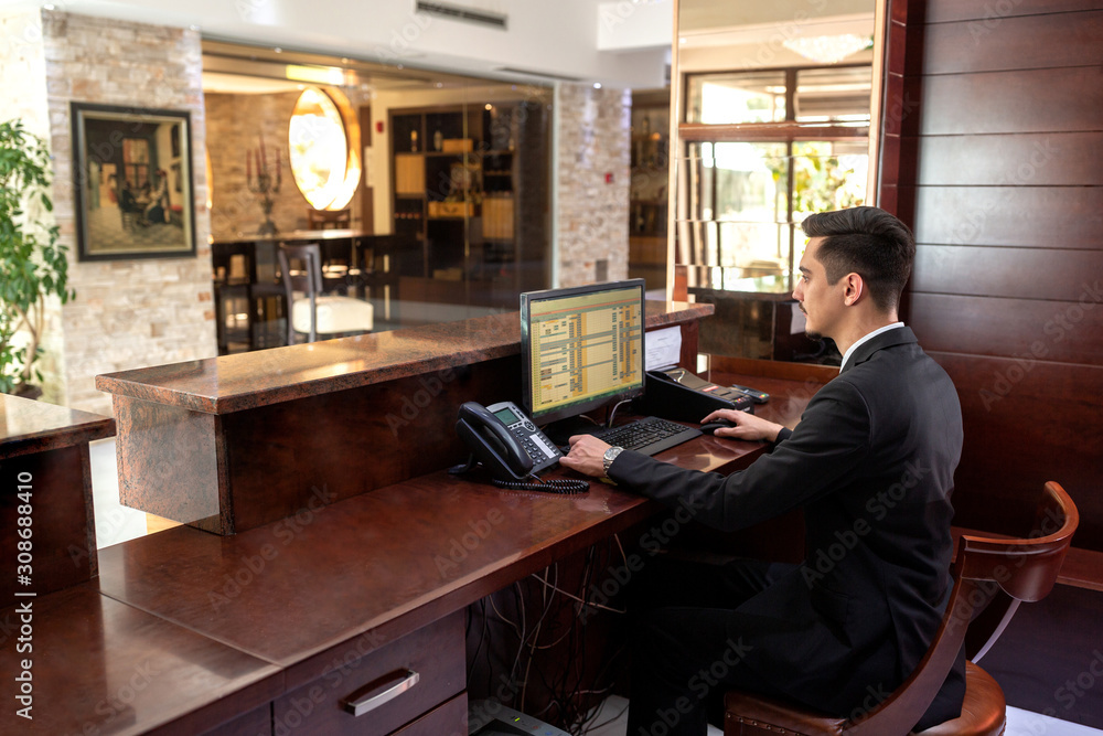 Front desk hotel receptionist working Stock Photo