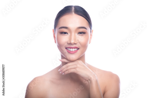 Beautiful Young Asian Woman with Clean Fresh Skin isolate on white background. Spa, Face care, Facial treatment, Beauty and Cosmetics concept. Left hand touch chin. Smile with teeth.