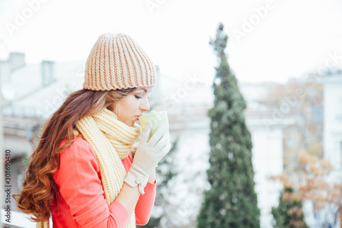 the girl in the hat froze and drinking hot tea photo