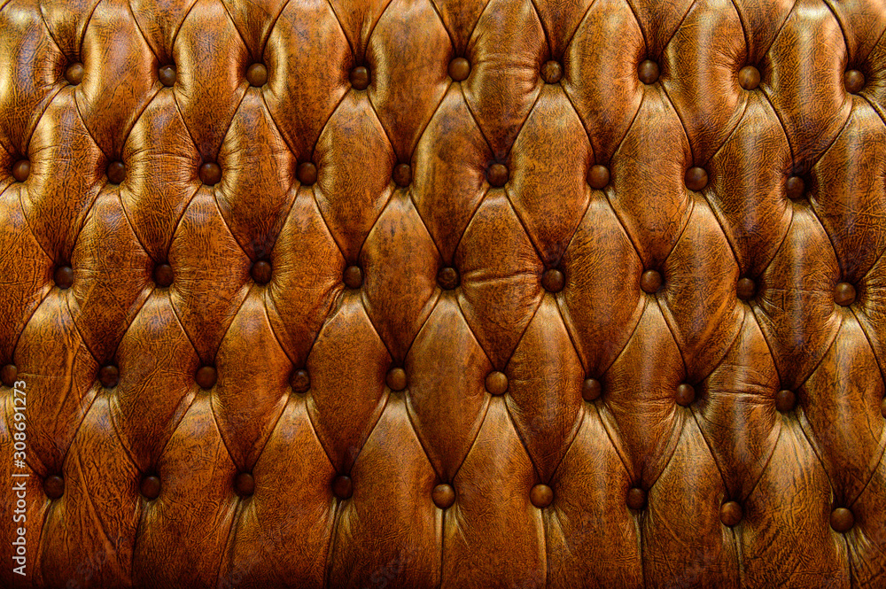 Fototapeta premium Texture of vintage brown leather sofa for background