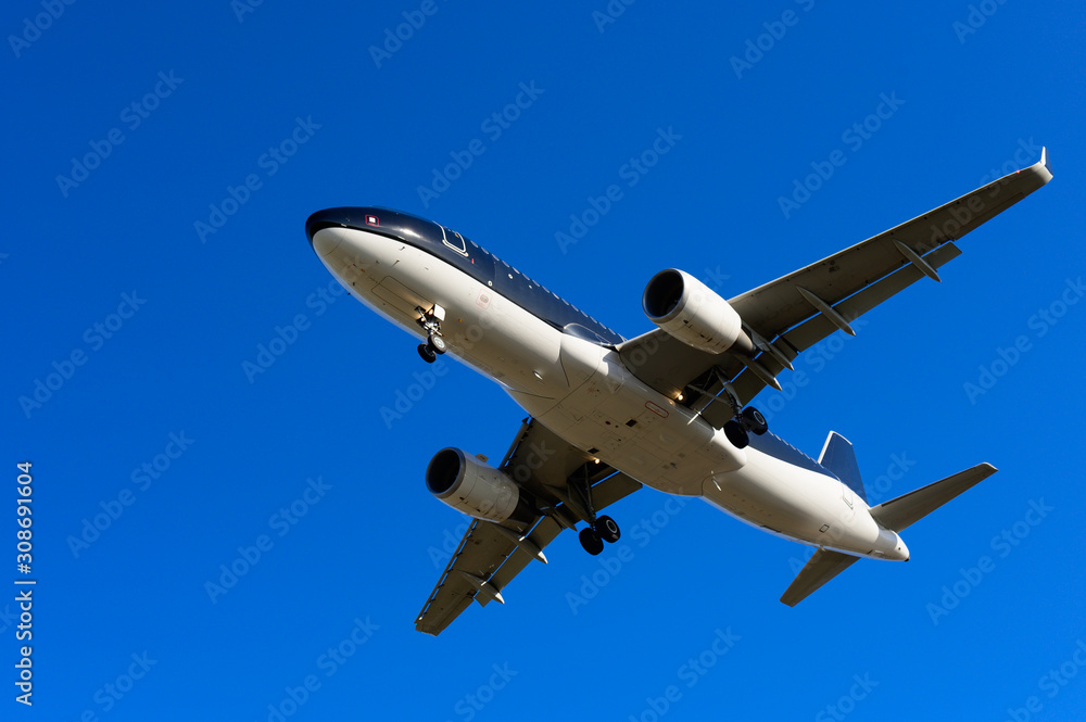 Airplane fly overhead against blue sky Airplane fly overhead against blue sky