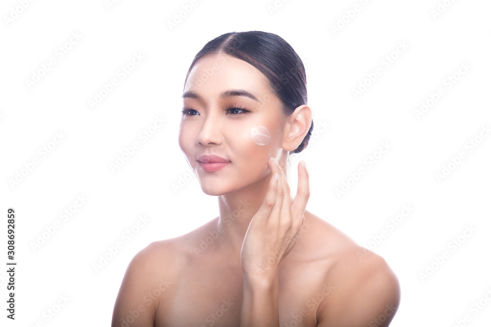 Beautiful Young Asian Woman with Clean Fresh Skin isolate on white background. Spa, Face care, Facial treatment, Beauty and Cosmetics concept. Cream on face, touching, smile.
