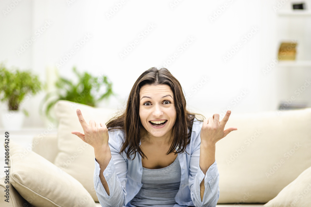 Happy woman looking at camera pointing up to imagimary item, isolated. Close up. Happy woman looking at camera pointing up to imagimary item, isolated. Close up.