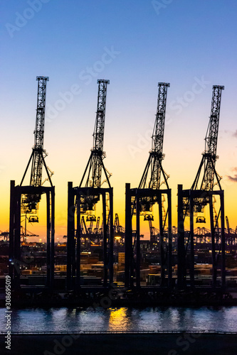 Hamburg harbour cranes at sunset 