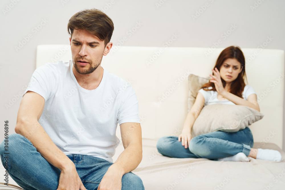 young couple sitting on sofa and watching tv young couple sitting on sofa and watching tv