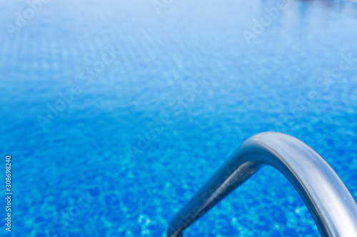 Grab bars stainless in the blue swimming pool © Suphansa