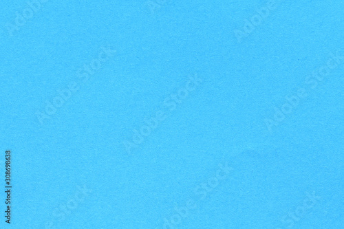 Blue blank piece of paper. A high resolution photo of paper ideal as a background or texture.