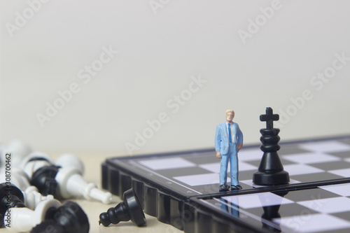 Simple illustration photo concept, 1 standing businessman mini figure toy help to winning war or Battle Small Magnetic Plastic chess King photo