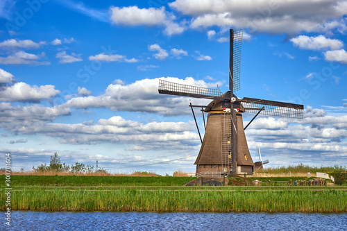 Beautiful dutch windmill under the cloudy sky in Kinderdijk