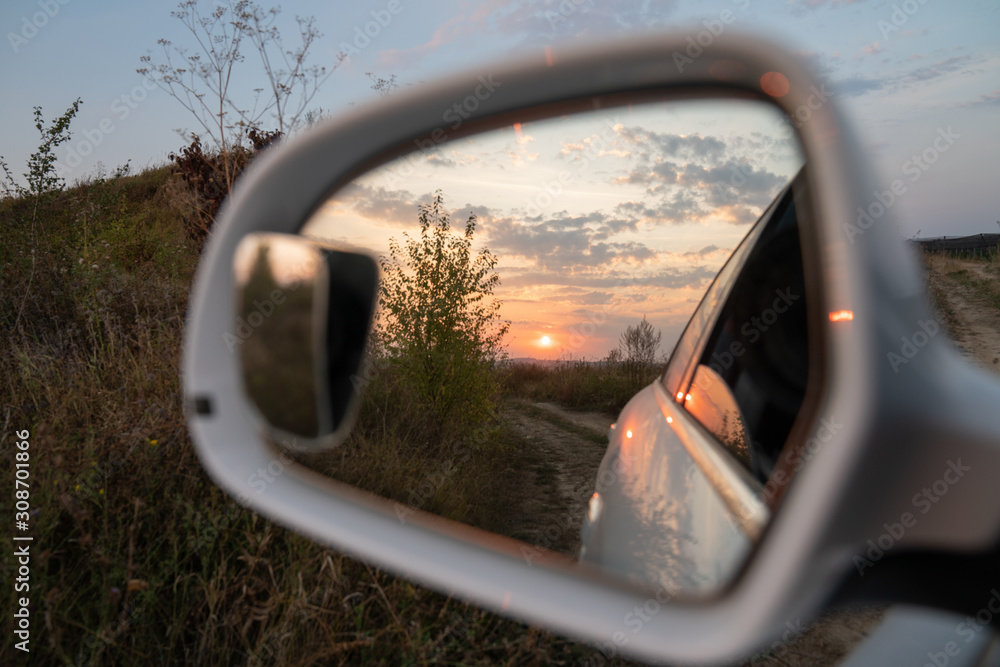 Beautiful sunset is displayed in the side mirror of the car Beautiful sunset is displayed in the side mirror of the car