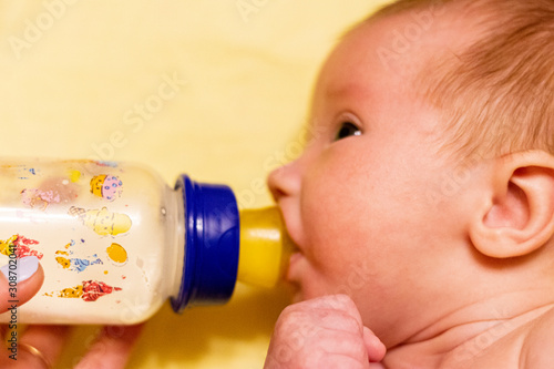 Charming mother feeding her adorable son in the kitchen at home