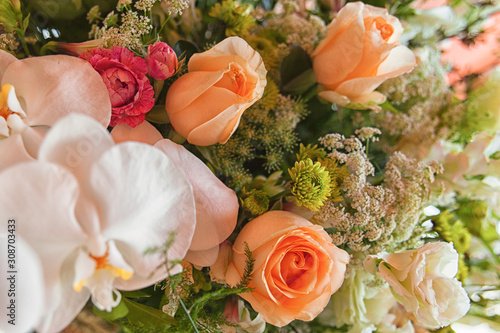 Beautifully decorated table with a bunch of fresh and beautiful flowers photo