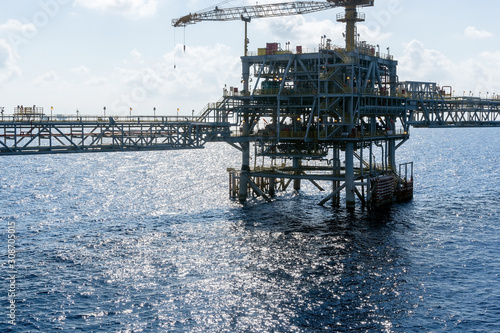 Silhouette of an oil production platform viewed during morning sunshine at oil field photo