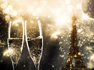 two glasses of champagne and Eiffel tower with fireworks New Year in Paris