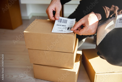 Delivery service, applying a shipping label	 photo