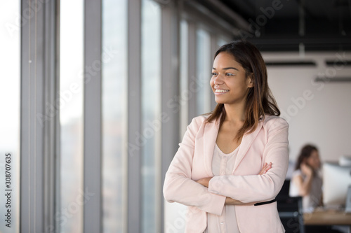 Free Download Smiling African American businesswoman standing in office, business vision - GFXLoad