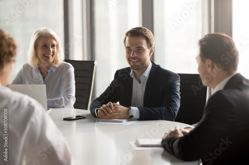 Wallpaper Mural Friendly employees laughing at company briefing, successful negotiation Torontodigital.ca