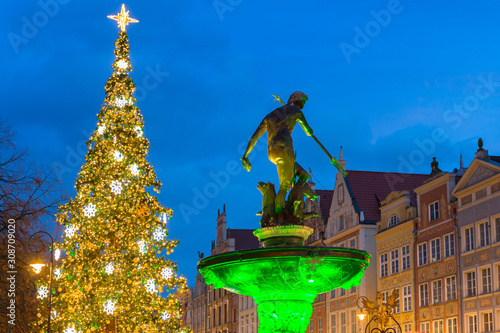 Long Lane and Neptune fountain in Gdansk with beautiful Christmas tree at dusk, Poland