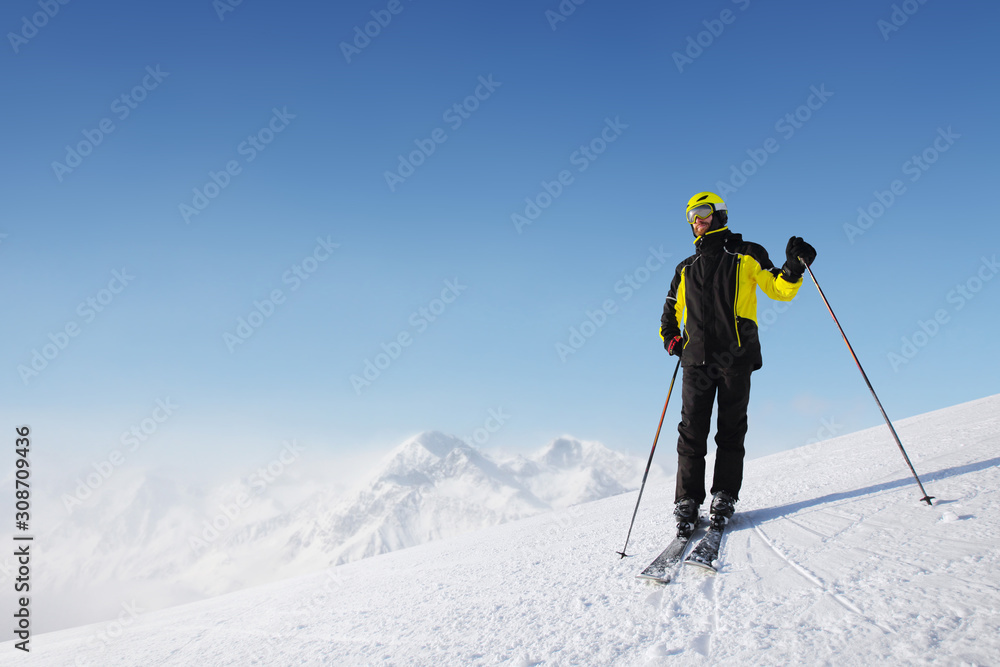 Skier standing on mountain slope Skier standing on mountain slope
