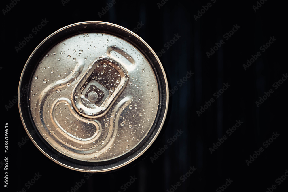 Closed can of cola on black background. Top view. Can drink with water drops. Copy, text space. Closed can of cola on black background. Top view. Can drink with water drops. Copy, text space.