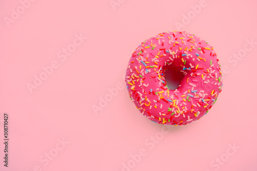 Pink round donut at bright pink background. Sweet donuts.  Trendy sunlight Summer pattern Minimal summer concept.